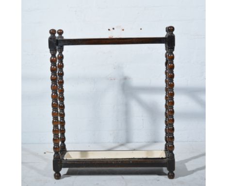 Oak hall mirror, and an oak stickstand with bobbin turned supports.