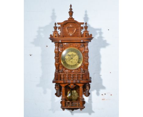 Reproduction German wall clock, brass dial, movement striking on twelve gongs, architectural pediment piece with an urn finia