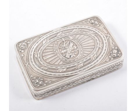 A large rectangular white metal snuff box, plain underside with decorated sides and cover with foliate spandrels to corners, 