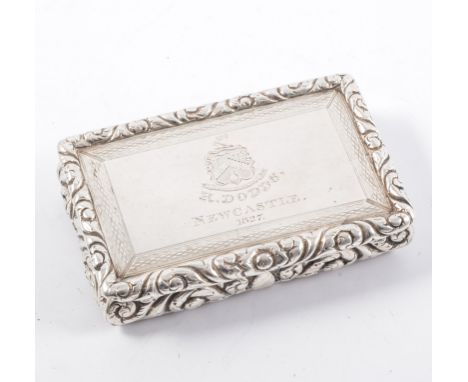 A George IV rectangular silver snuff box, engine turned base and border to cover with rased scroll and foliate sides, the cov
