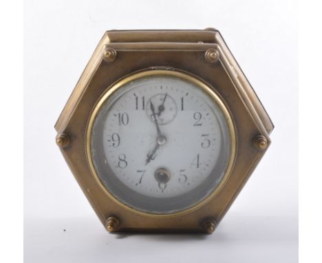 Brass cased table clock, hexagonal design, white enamelled dial with Arabic numerals, the sides with six glass panels, height