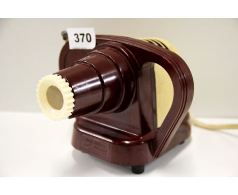 A boxed red Bakelite junior viewmaster projector.