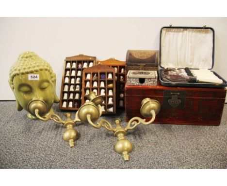 A pair of brass wall sconces, a ceramic Buddha head and other items.