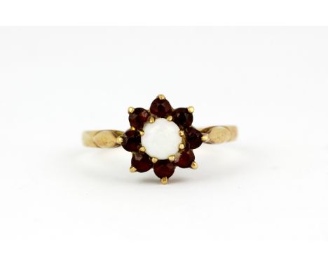 A 9ct yellow gold garnet and opal set cluster ring, (O).