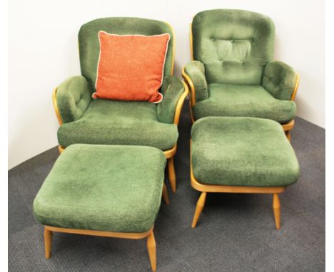 A pair of vintage Ercol upholstered armchairs and footstools.