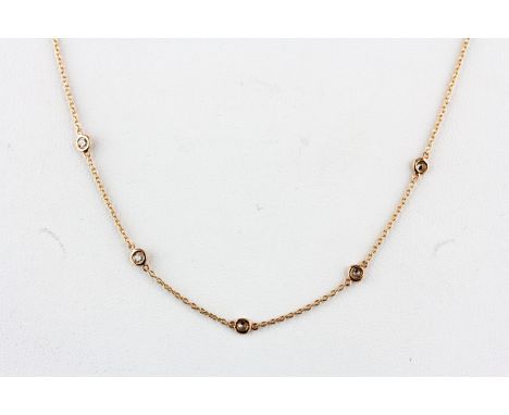 An 18ct rose gold (stamped 750) brilliant cut diamond set chain, L. 42cm.