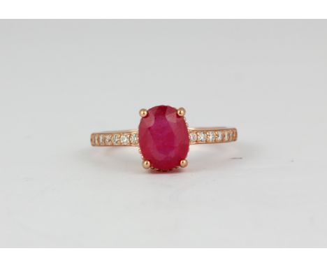 A 925 silver rose gold gilt oval cut ruby and white stone set ring, (P).