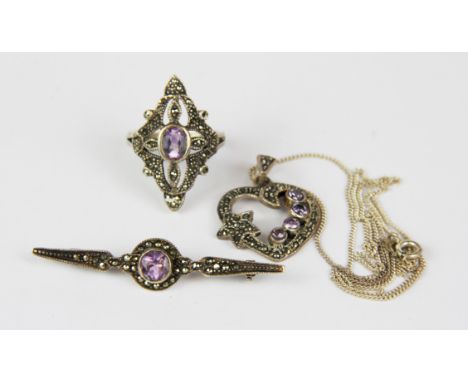 A set of silver marcasite and amethyst jewellery, comprising of a ring, a pendant with chain and brooch.