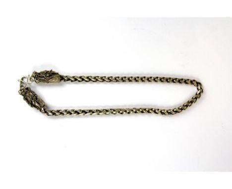 A heavy Chinese white metal dragon head chain necklace, L. 32cm.