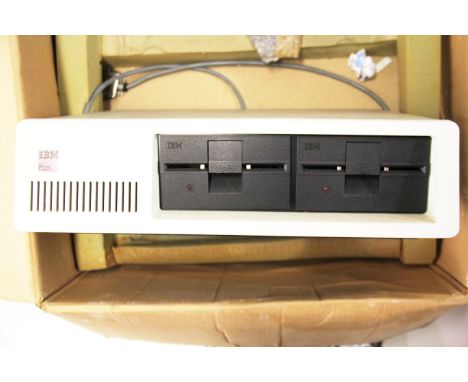 A boxed vintage Amstrad PC 1640 and an IBM personal computer.