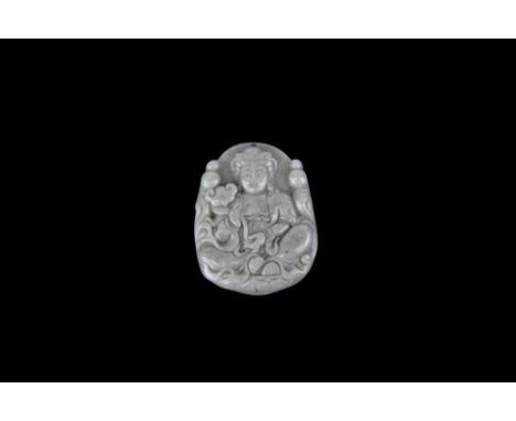A finely carved jade amulet of the seated goddess Guanyin holding a ruyi, W. 4cm.