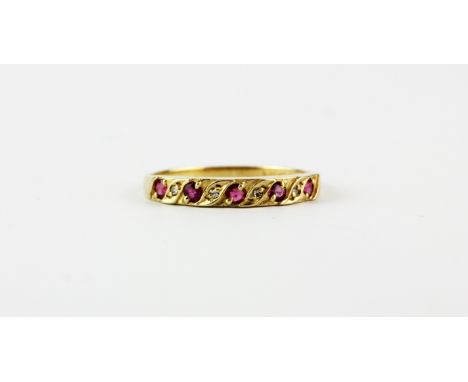 A 9ct yellow gold ruby and diamond set half eternity ring, (N.5).