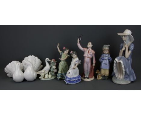 Five Lladro figurines and two Nao figurines, tallest H. 27cm.