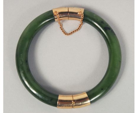 A CHINESE SPINACH JADE BANGLE, 8cm diameter.