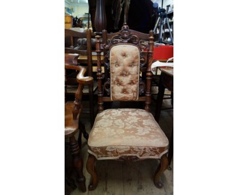 A Victorian carved walnut and button upholstered occasional chair. 