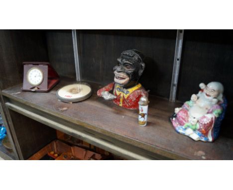 A mixed lot, comprising: a 'Jolly Nigger' type money box; an easel back photograph frame; a vintage easel timepiece; a Chines