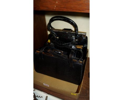Three vintage black leather handbags, and similar purses. 