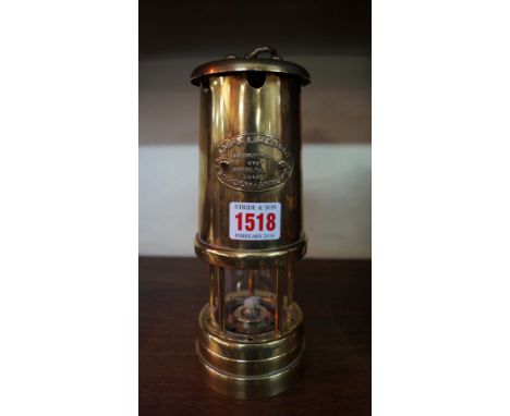 A Hockley Lamp & Limelight Company brass miner's type lamp, 22cm high.