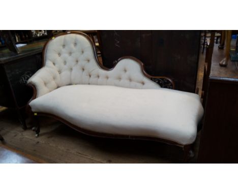 A Victorian mahogany framed button upholstered chaise longue, of serpentine outline. 