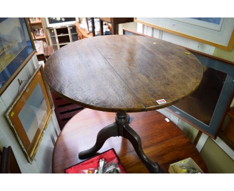 A George III oak circular tilt-top tripod table, 83.5cm diameter. 