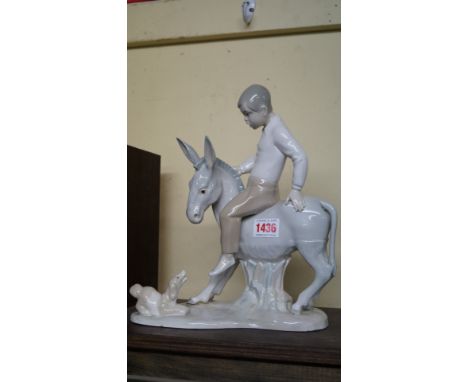 An early Nao figure group of a boy on a donkey, 28cm high, (s.d.).