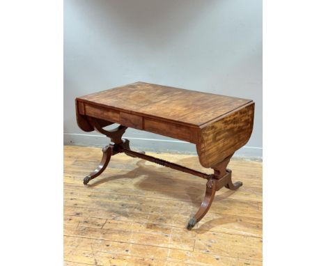 A Regency mahogany sofa table, c. 1820, of characteristic form, with twin flaps and fitted with two frieze drawers opposed by
