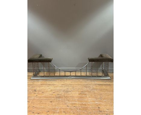 A steel and brass club fender, with twist and square-section uprights supporting a padded corduroy seat. 53cm by 208cm by 61c