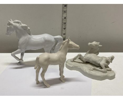 A selection of white ceramic horses including Royal Doulton 