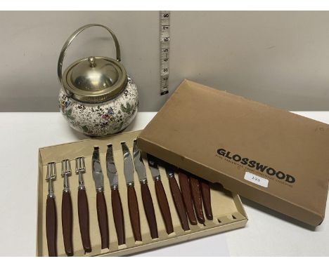 A vintage ceramic and brass biscuit barrel and a selection of cutlery 