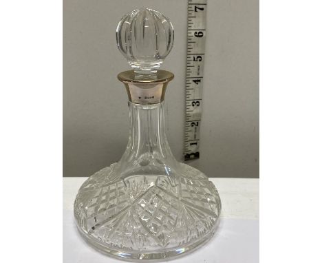 A hallmarked silver collared small decanter 