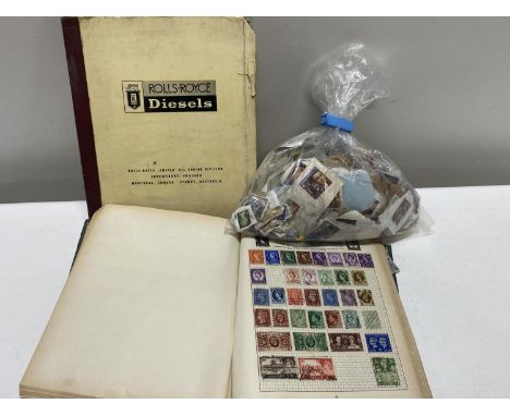 A stamp album and selection of loose stamps with a Rolls Royce diesel manual 