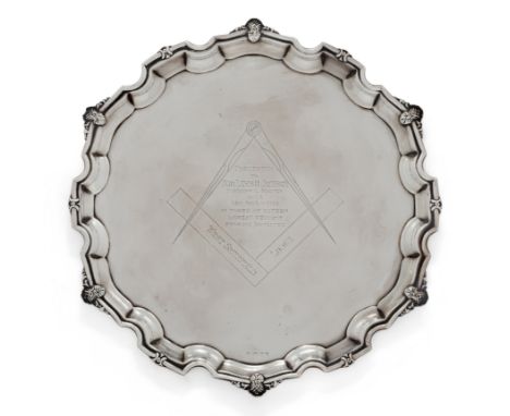 Of Masonic interest. A George V silver salver. Maker's mark indistinct. Birmingham, 1928. Of circular form, the Chippendale b