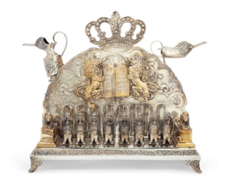 A German parcel gilt silver Hanukkah oil menorah. Late 19th/early 20th century. Stamped 900. The rectangular base supporting 