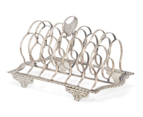 A Georgian silver six division toast rack. Crispin Fuller, London, 1820. The seven bars to a shaped base with gadrooned borde