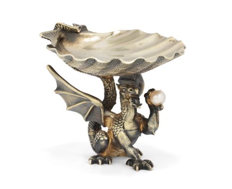 A limited edition parcel gilt silver dragon salt. Hector Miller, London, 1982. Designed as a cast, winged dragon holding a cu