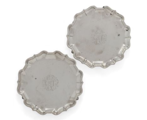 A pair of George II Britannia silver waiters. Francis Nelme, London, 1734. Of shaped, circular form with Chippendale-style bo