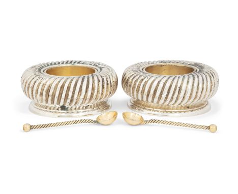 A pair of lobed parcel gilt silver salts. Asprey & Co., London, 1993. Of circular form with clear glass liners, each raised o