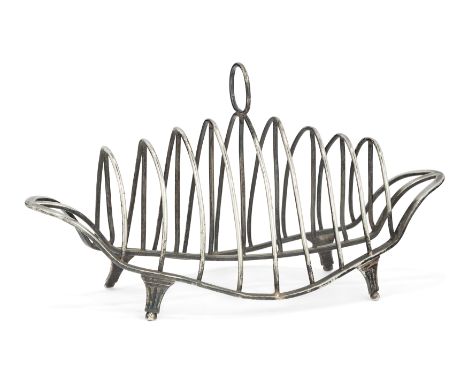 A George III silver toast rack. London, 1789. Maker's mark indistinct. The navette-shaped base raised on four columnar feet a
