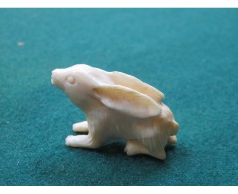 MINIATURE IVORY NETSUKE OF A HARE 