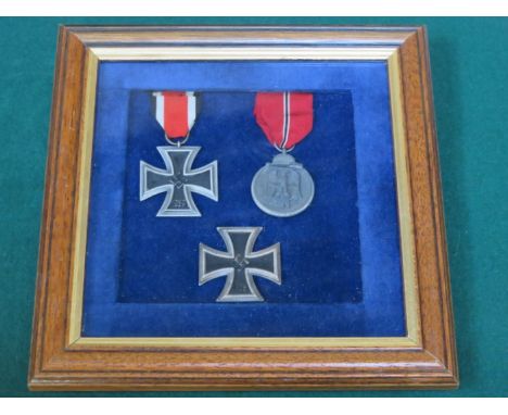 FRAMED FIRST AND SECOND CLASS WORLD WAR II GERMAN IRON CROSSES PLUS ANOTHER GERMAN MEDAL 