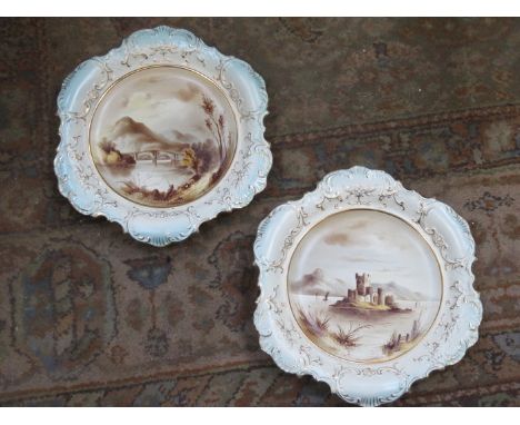 PAIR OF VICTORIAN CERAMIC WALL PLAQUES WITH GILDED AD HANDPAINTED SCENES OF LOCH LEVAN AND OLD GARTH BRIG, BOTH INITIALLED GH