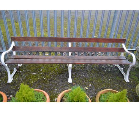A VICTORIAN WHITE GROUND CAST IRON TRIPLE SUPPORT GARDEN BENCH, with five stained teak slats, marked at ends reading Spencer 