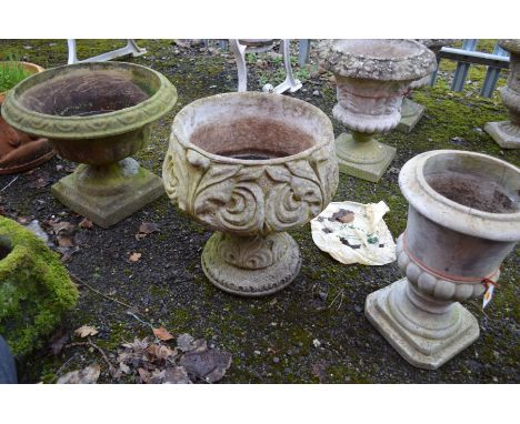 A CIRCULAR COMPOSITE COMPAGNA GARDEN URN, diameter 54cm x height 44cm, together with a composite foliate garden urn and anoth