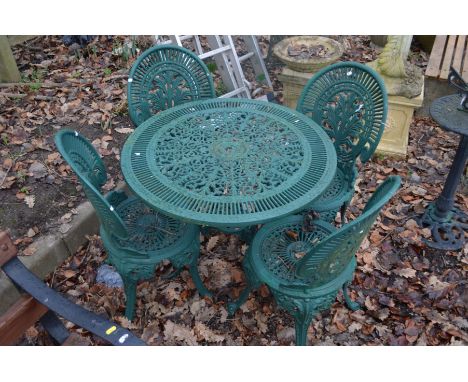 A GREEN PAINTED ALUMINIUM CIRCULAR GARDEN TABLE, diameter 80cm x height 66cm and four matching chairs (5)