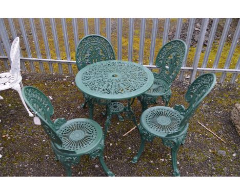 A CIRCULAR GREEN GROUND ALUMINIUM GARDEN TABLE, diameter 67cm x height 65cm and four matching chairs (5)