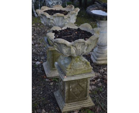 A PAIR OF COMPOSITE GARDEN URNS, on a separate plinth, diameter 54cm x overall height 84cm (2)