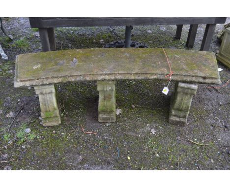A COMPOSITE CURVED GARDEN BENCH, on triple scrolled bench, width 152cm