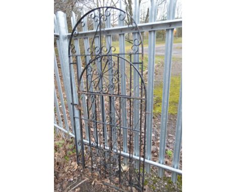 A BLACK GROUND WROUGHT IRON GARDEN GATE, with an arched top, width 92cm x 196cm, together with a similar smaller garden gate,