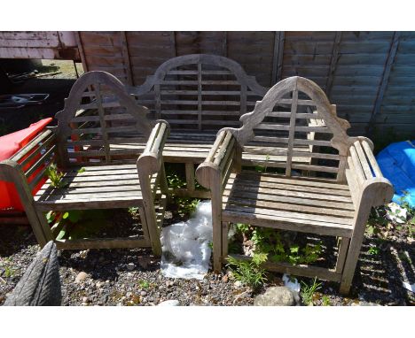 A SLATTED TEAK THREE PIECE GARDEN BENCH SET, comprising a three seater bench, width 196cm and two armchairs