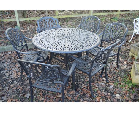 A MODERN ALUMINIUM BLACK GROUND CIRCULAR GARDEN TABLE, diameter 120cm x height 74cm and six matching armchairs (7)